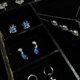 Earring storage section featuring handcrafted Blue Morpho butterfly wing earrings inside a luxury jewelry box.