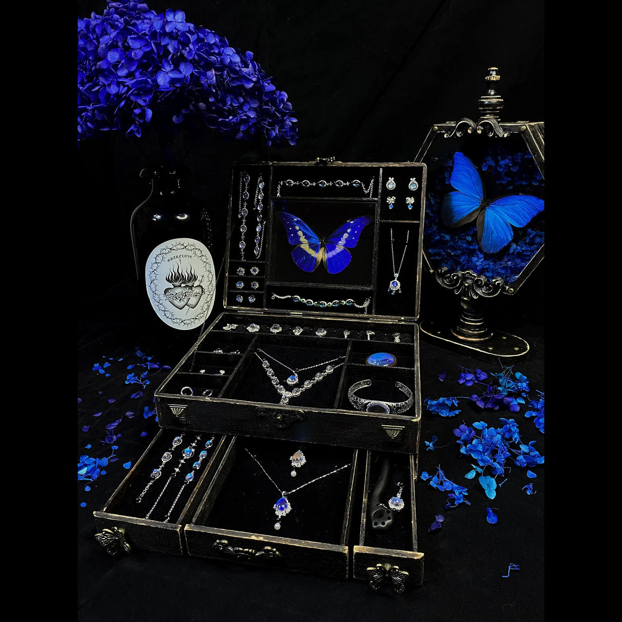 Collector-style Blue Morpho butterfly jewelry box displayed with matching handmade butterfly wing jewelry and vintage décor details.