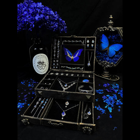 Collector-style Blue Morpho butterfly jewelry box displayed with matching handmade butterfly wing jewelry and vintage décor details.